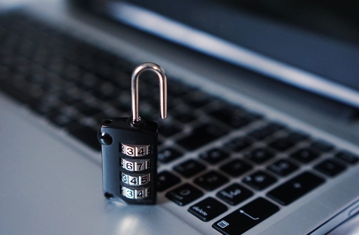 A combination padlock sitting on a laptop keyboard