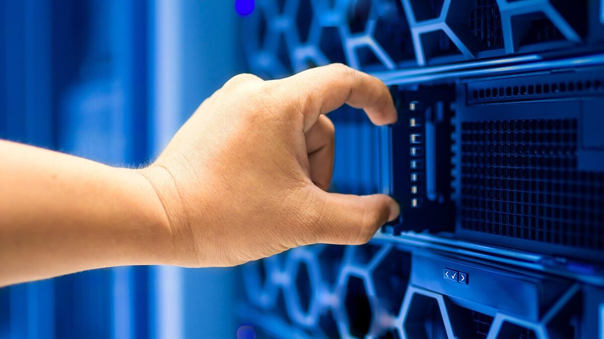 Hand fitting a blade into a data centre rack