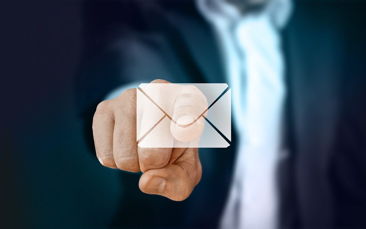 Finger touching a floating email icon