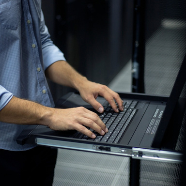 Hands typing on a laptop keyboard